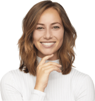 A young woman with shoulder-length light brown hair smiles warmly. She is wearing a white, long-sleeved, ribbed turtleneck and is touching her chin with one hand. The background is transparent.